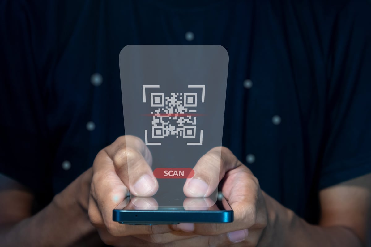 Male hand using a smart phone to scan QR code